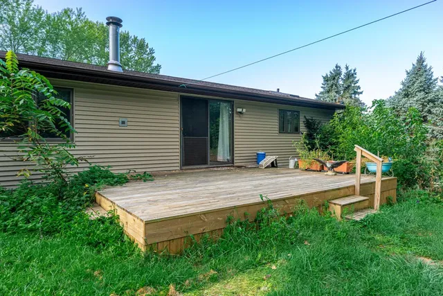 a view of a house with a backyard and plants