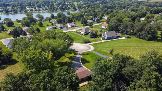 an aerial view of residential houses with outdoor space and swimming pool