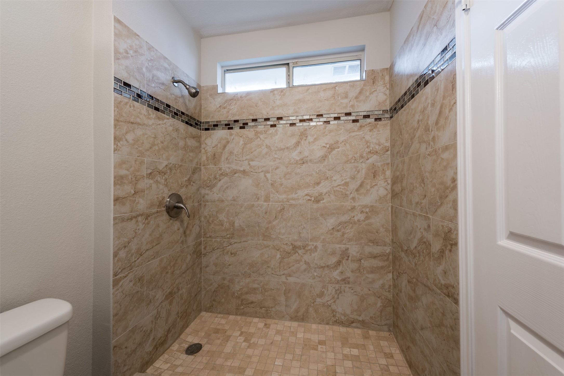5703 Teri Road Austin, TX 78744 - Photo 11 of 16 a bathroom with a shower