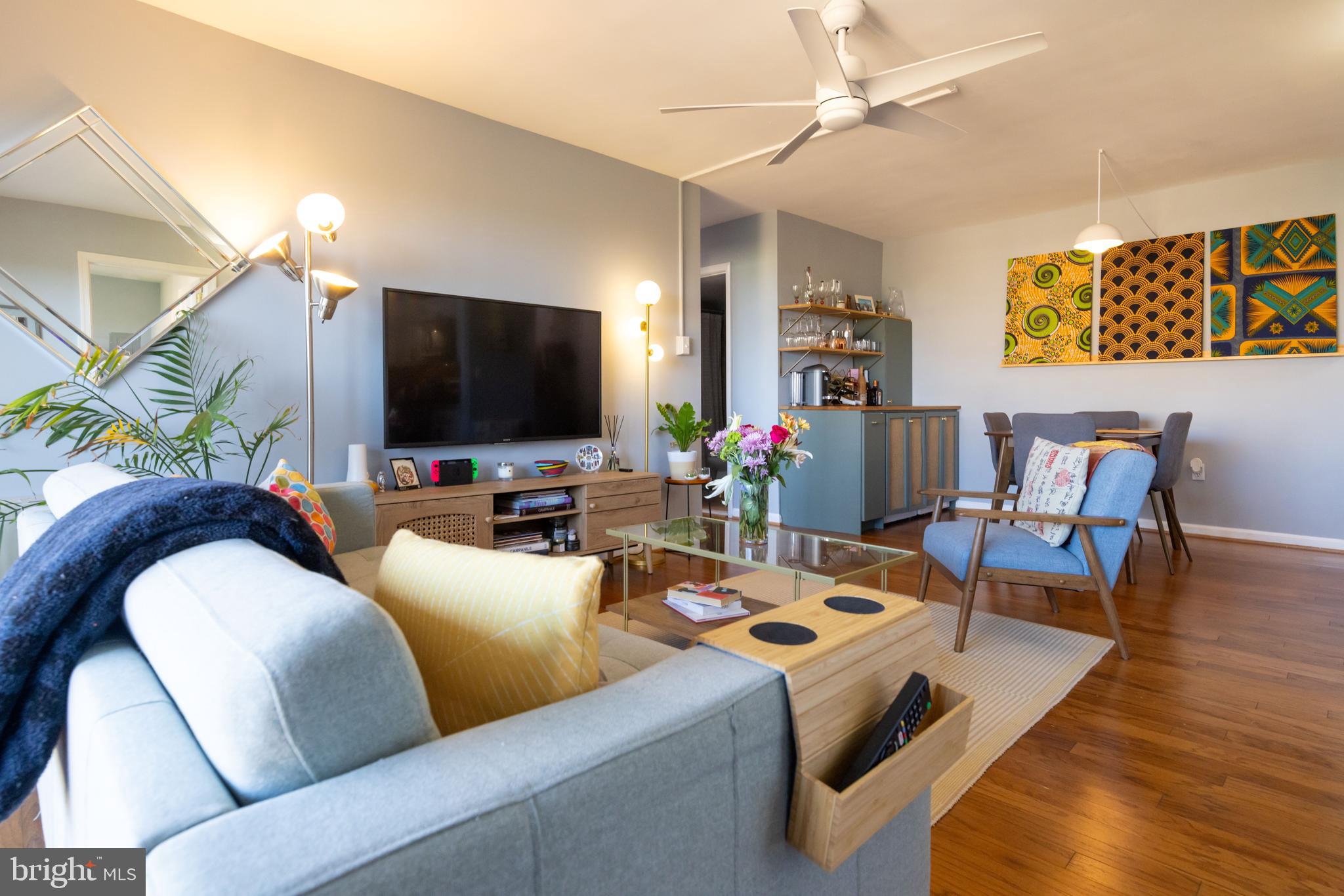 a living room with furniture and wooden floor