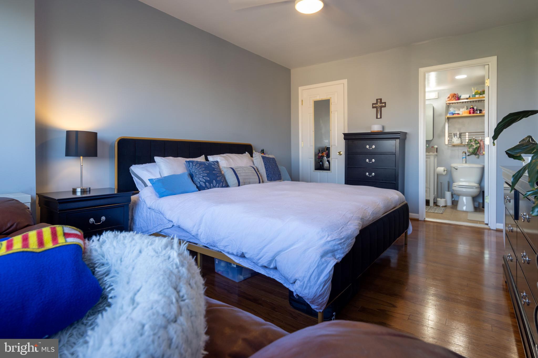 8830 Piney Branch Road, Unit 1207 Silver Spring, MD 20903 - Photo 19 of 38 a bedroom with a bed and a view of living room