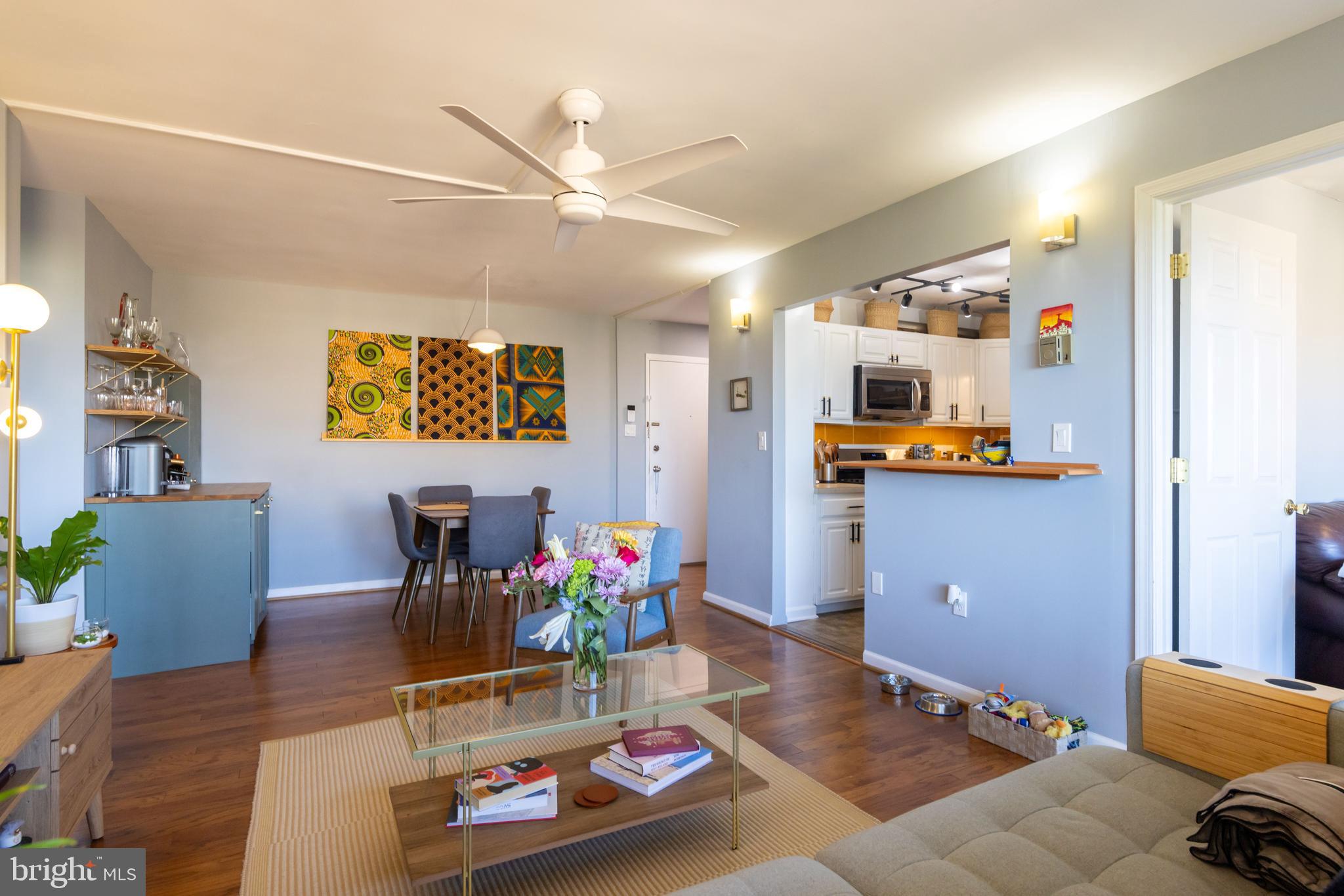 8830 Piney Branch Road, Unit 1207 Silver Spring, MD 20903 - Photo 2 of 38 a living room with furniture and flowers