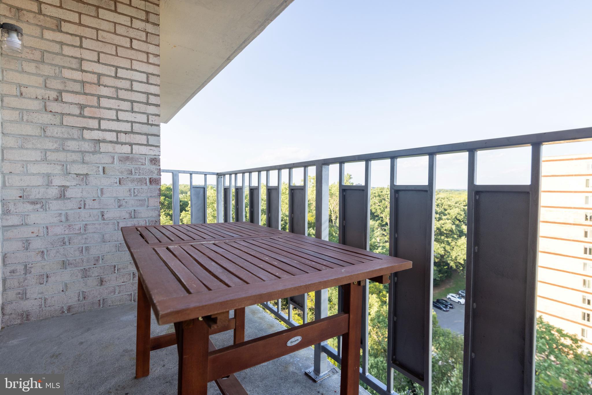 8830 Piney Branch Road, Unit 1207 Silver Spring, MD 20903 - Photo 27 of 38 a view of a balcony with table and chairs