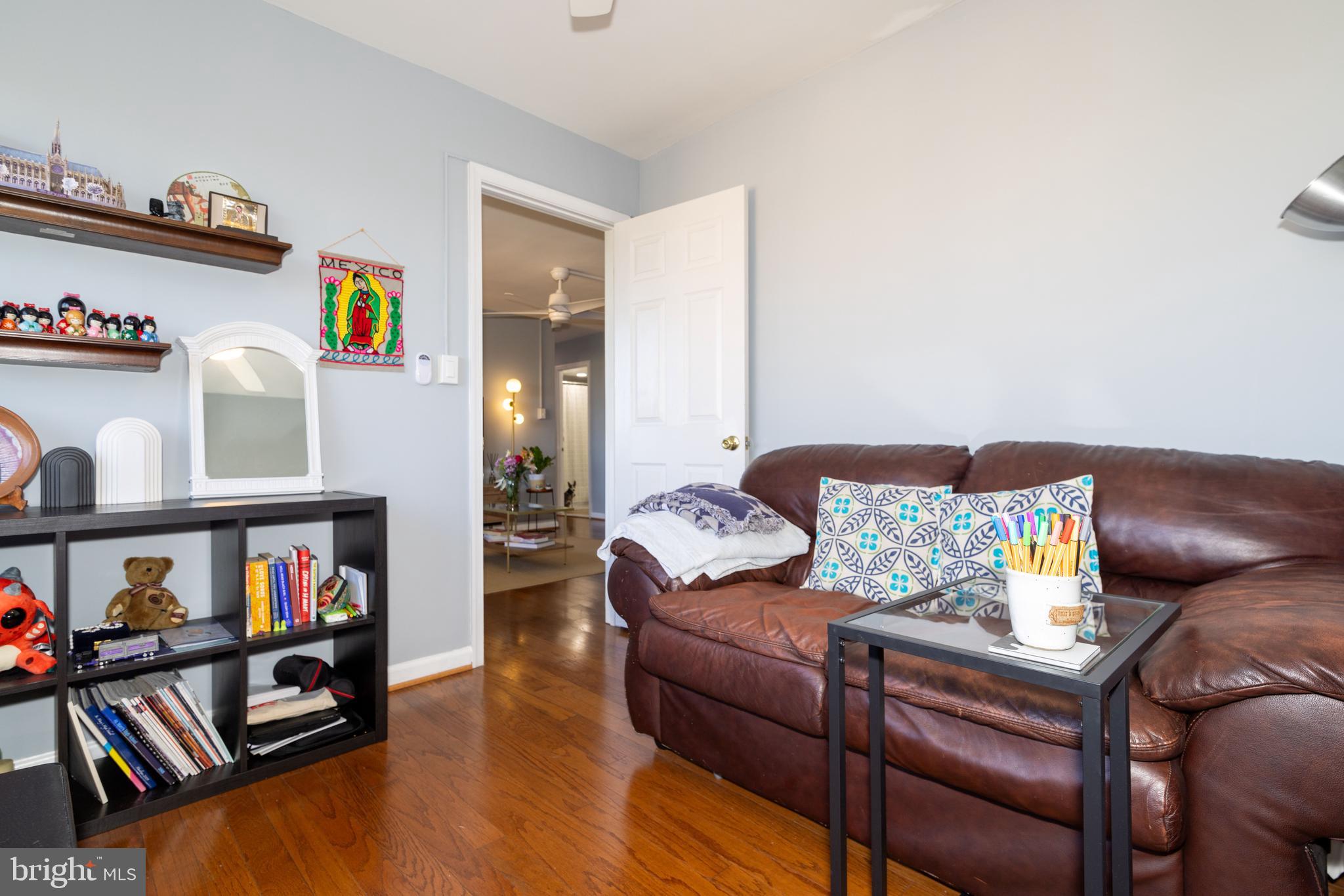 8830 Piney Branch Road, Unit 1207 Silver Spring, MD 20903 - Photo 7 of 38 a living room with furniture and a book shelf