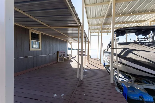 an aerial view of a house with lake view and a trees