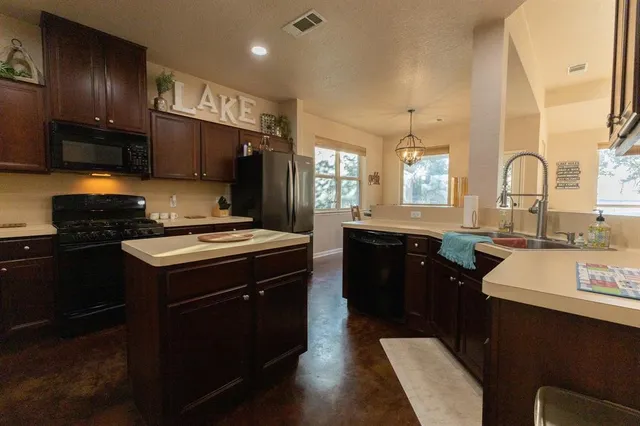 a kitchen with a sink stove and refrigerator