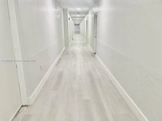 a living room with patio furniture and a flat screen tv