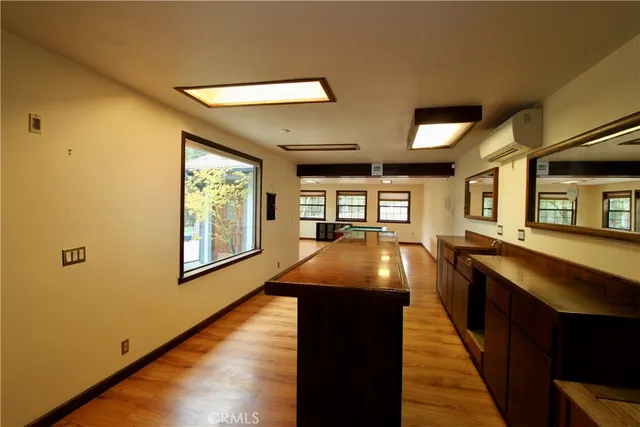 a kitchen with stainless steel appliances granite countertop a stove and a wooden floors