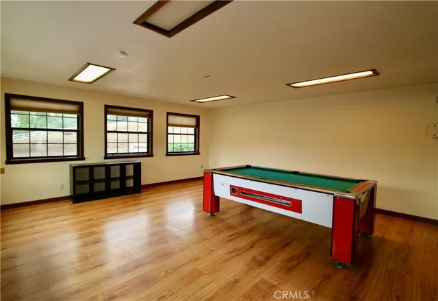 a living room with kitchen view and wooden floor