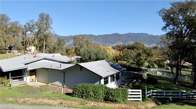 a view of a house with a yard and sitting area