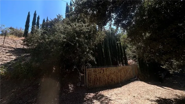 a view of wooden fence and trees