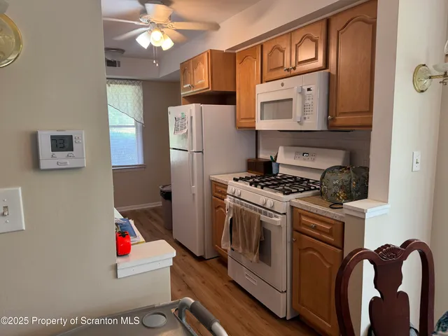 a kitchen with stainless steel appliances granite countertop a refrigerator a stove and a sink