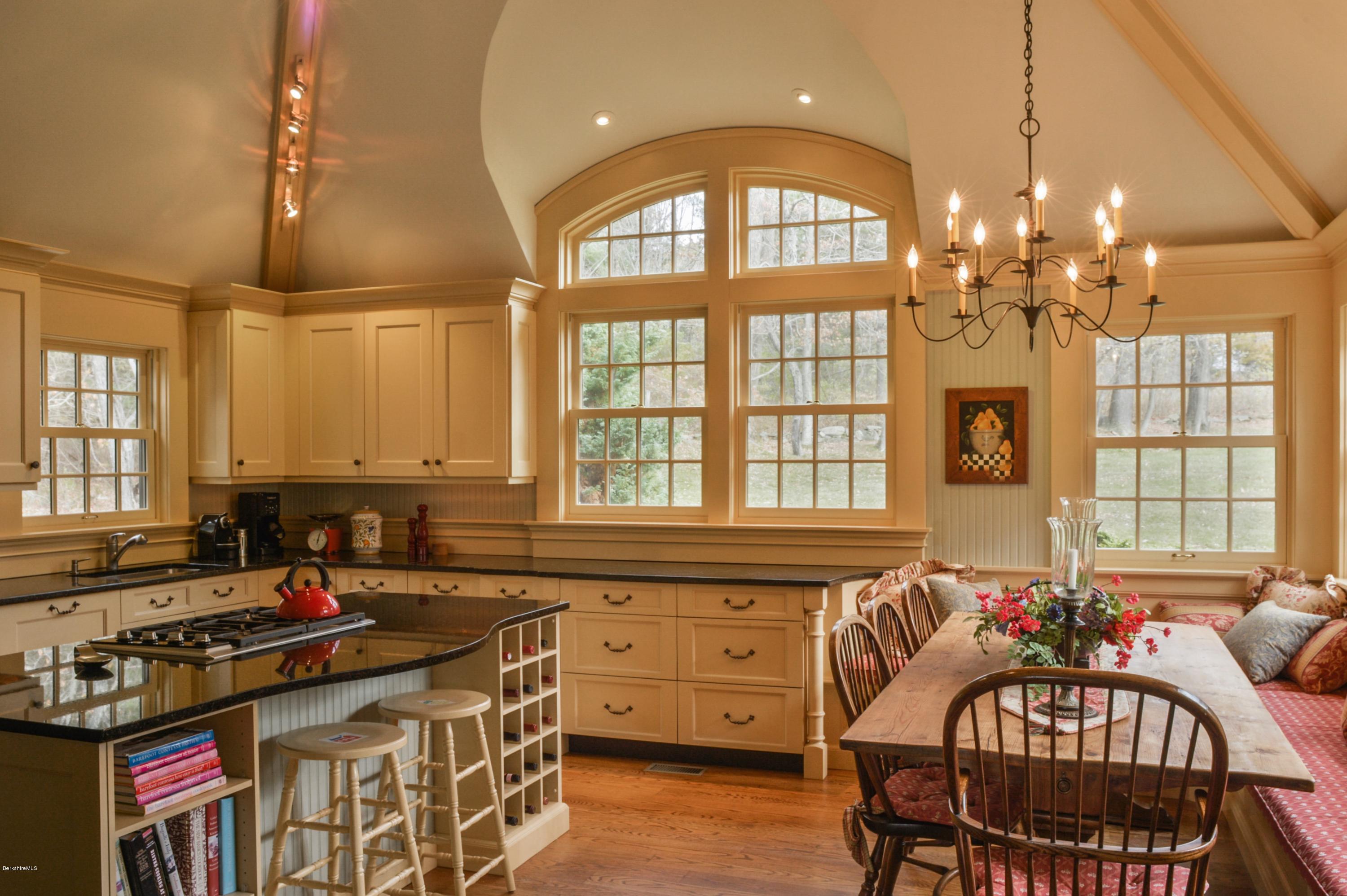 22 Tyringham Road Monterey, MA 01245 - Photo 7 of 24 a kitchen that has a stove a table and chairs in it
