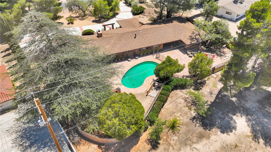 19955 Chickasaw Road Apple Valley, CA 92307 - Photo 55 of 60 an aerial view of a house with a yard and large trees