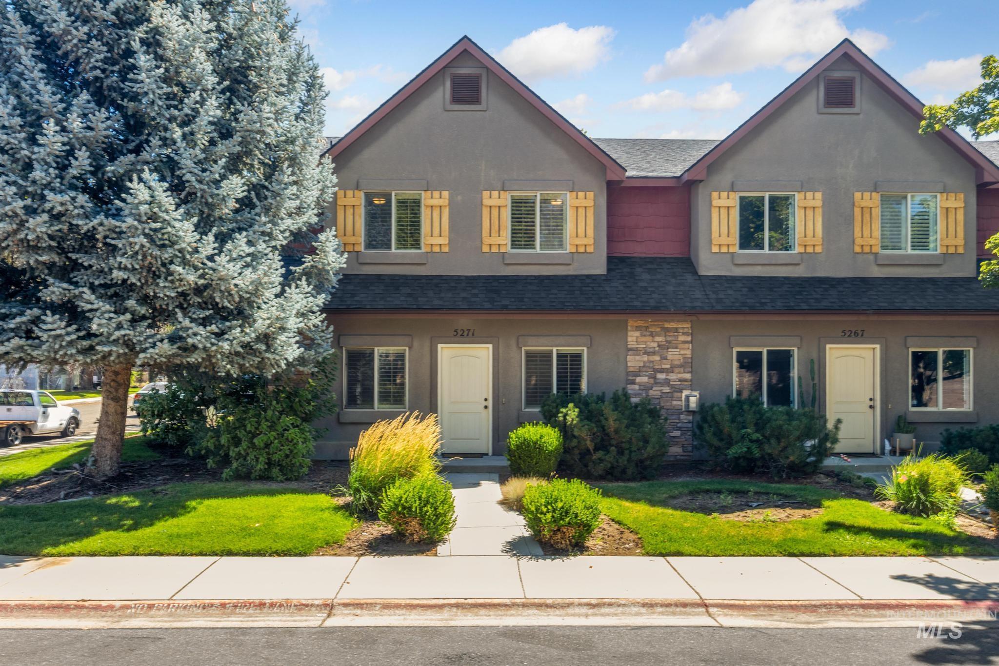 5271 West Morris Hill Road Boise, ID 83706 - Photo 1 of 31 View of front of home featuring roof with shingles, a front yard, stone siding, and stucco siding