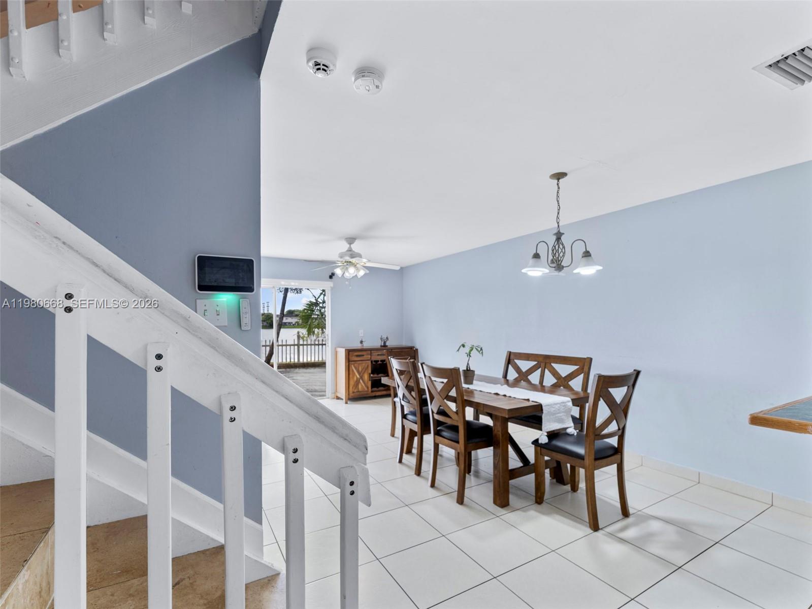 17337 Southwest 140th Court Miami, FL 33177 - Photo 11 of 41 a view of a dining room and hall with furniture