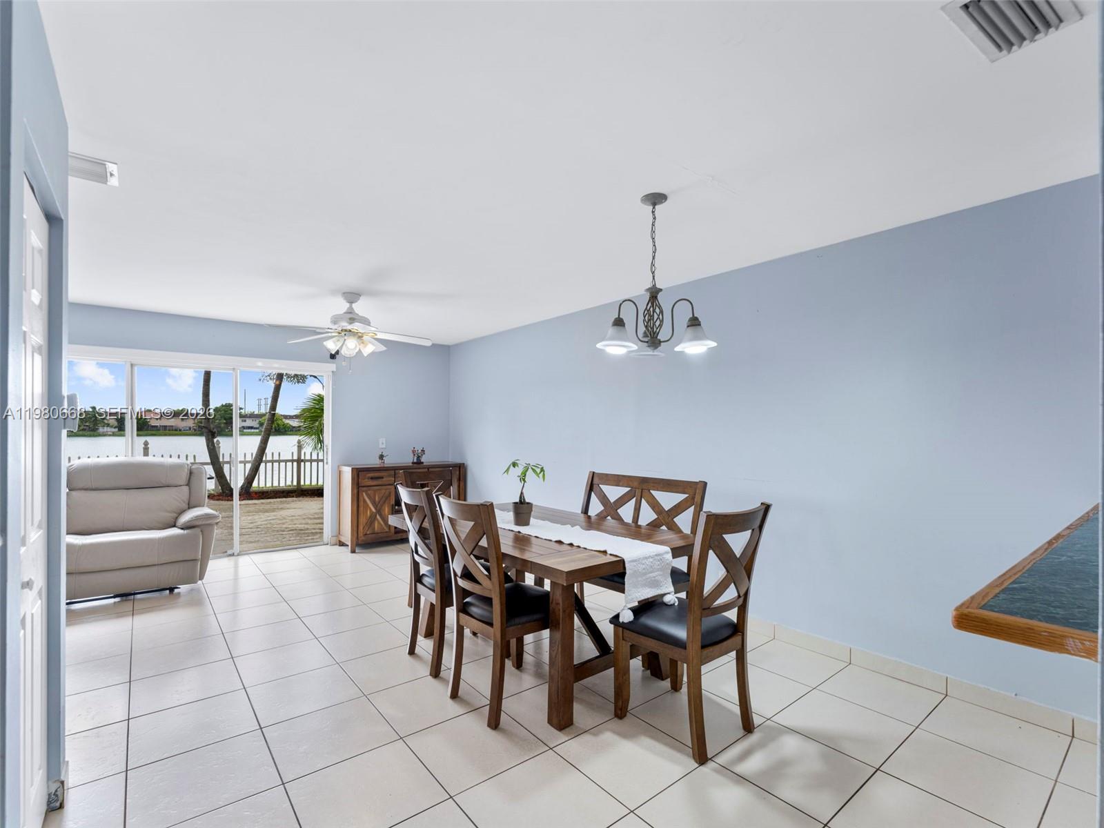 17337 Southwest 140th Court Miami, FL 33177 - Photo 12 of 41 a view of a dining room with furniture wooden floor and a chandelier