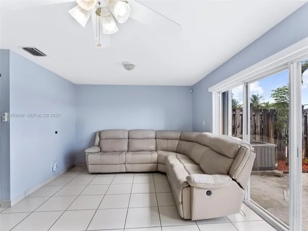 a living room with furniture and a large window