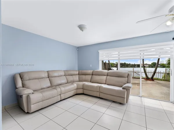 a living room with furniture and a glass door