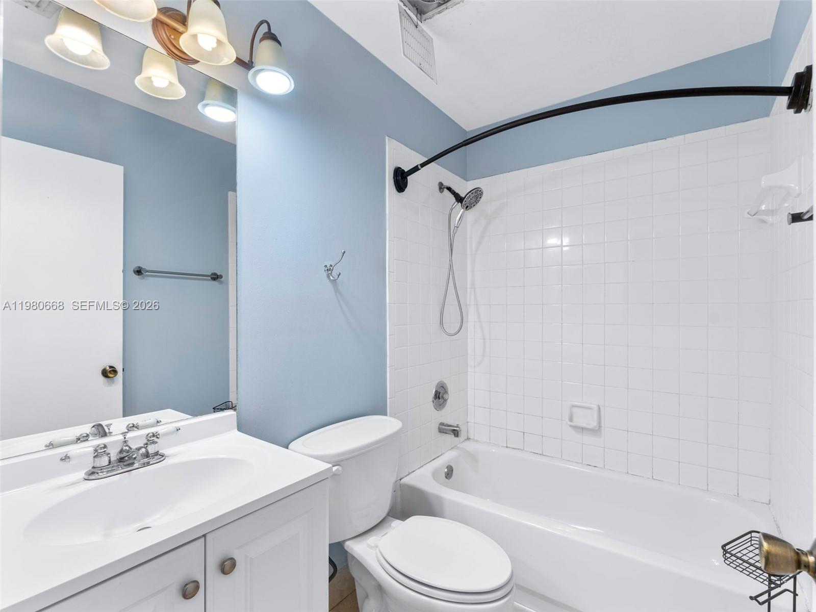 17337 Southwest 140th Court Miami, FL 33177 - Photo 26 of 41 a bathroom with a sink a toilet a mirror and shower