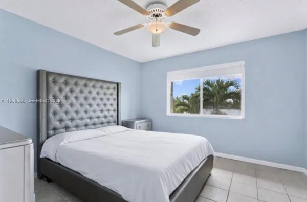 a bedroom with a bed and a painting on the wall