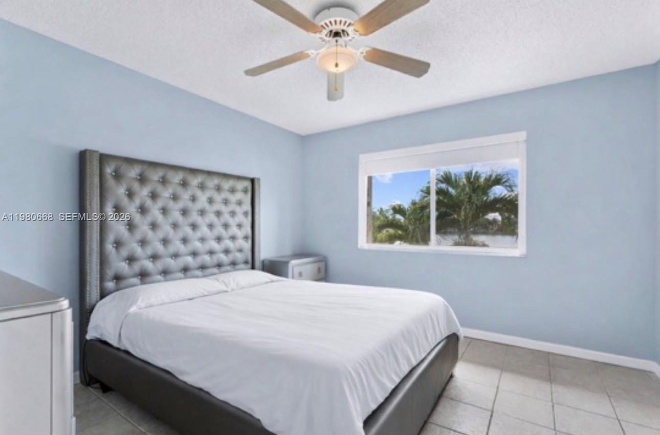 17337 Southwest 140th Court Miami, FL 33177 - Photo 30 of 41 a bedroom with a bed and a painting on the wall