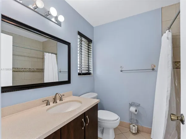 a bathroom with a sink vanity and a toilet