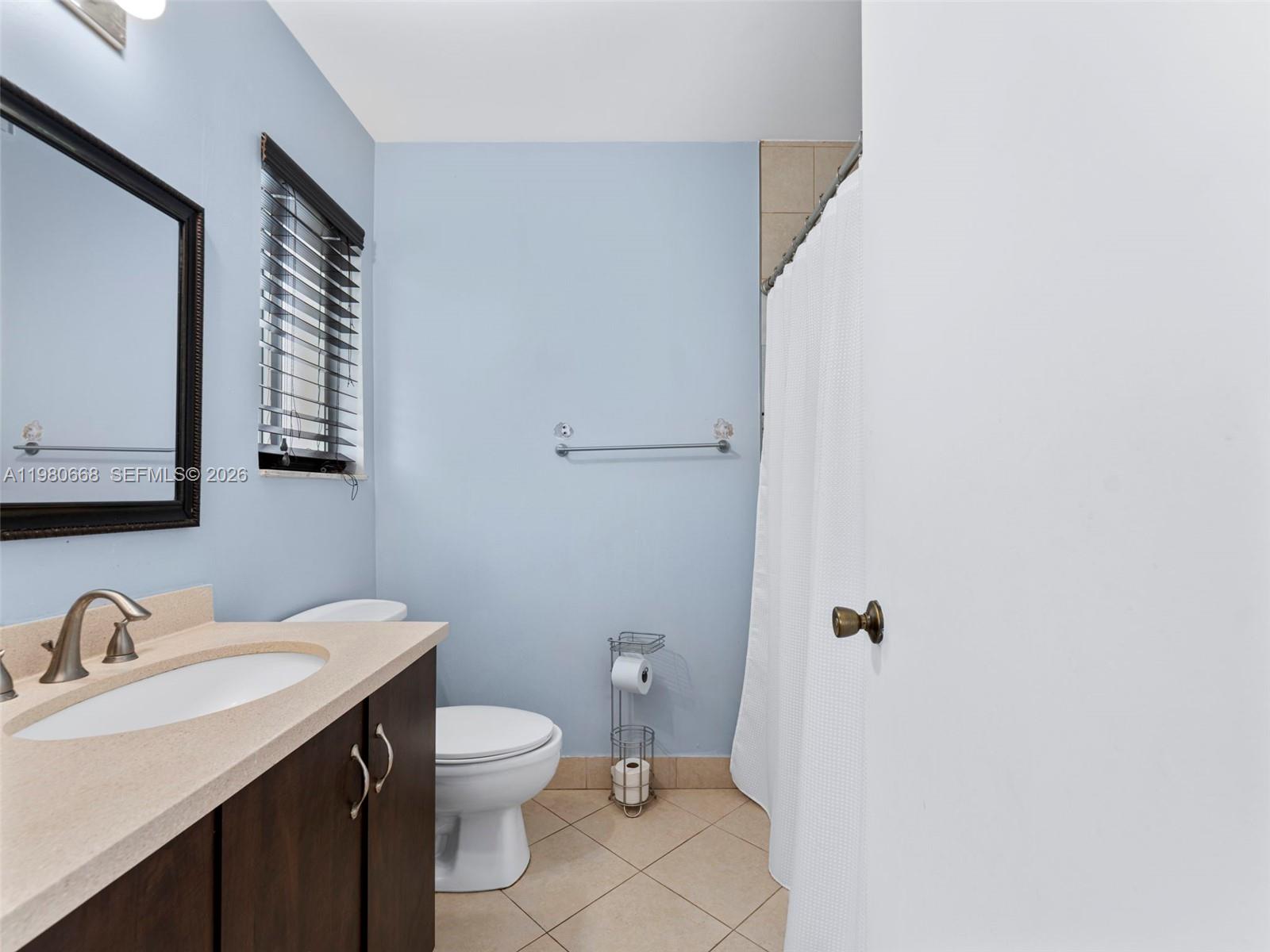17337 Southwest 140th Court Miami, FL 33177 - Photo 33 of 41 a bathroom with a sink a toilet and mirror