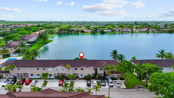 an aerial view of lake and residential houses with outdoor space and ocean view