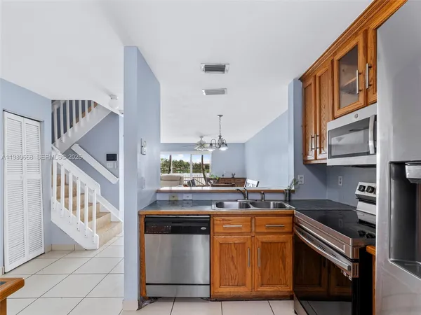 a kitchen with granite countertop a sink stove and cabinets