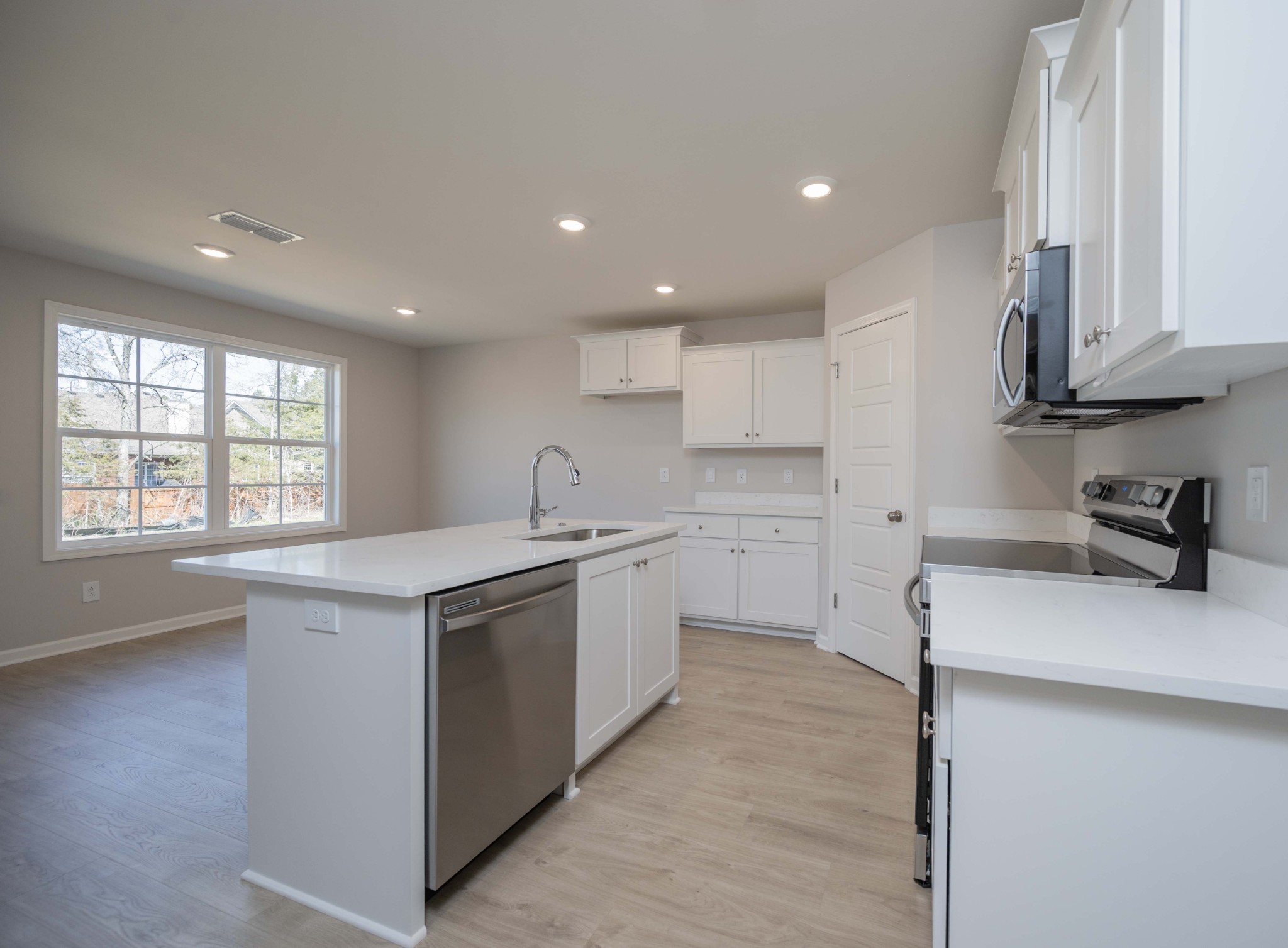 1313 Lakewalk Drive Antioch, TN 37013 - Photo 13 of 28 a kitchen with white cabinets appliances a sink and a window
