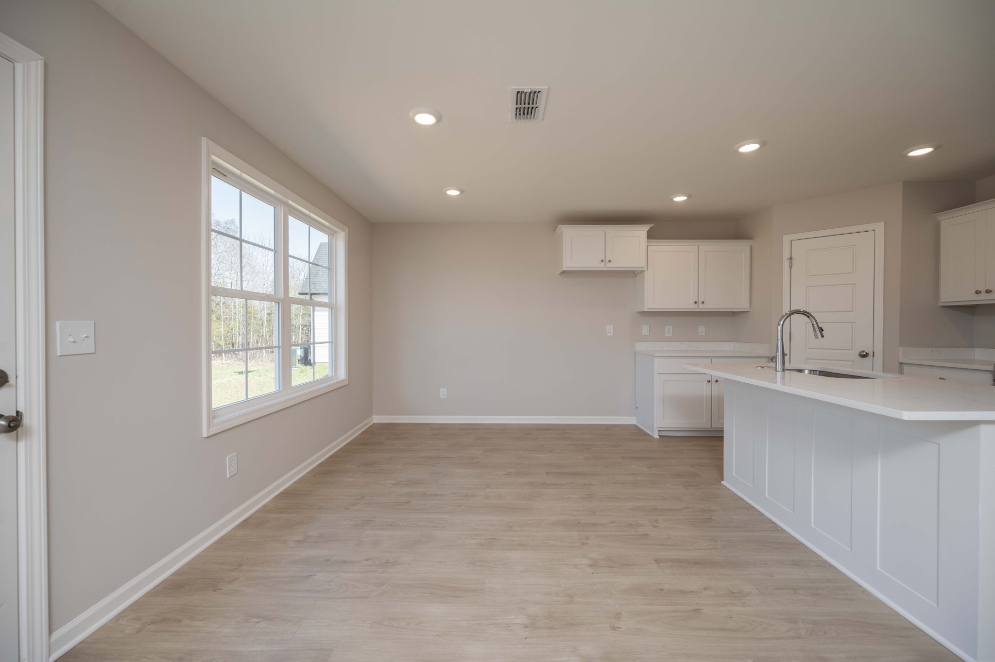 1313 Lakewalk Drive Antioch, TN 37013 - Photo 8 of 28 a view of an empty room with kitchen sink and wooden floor