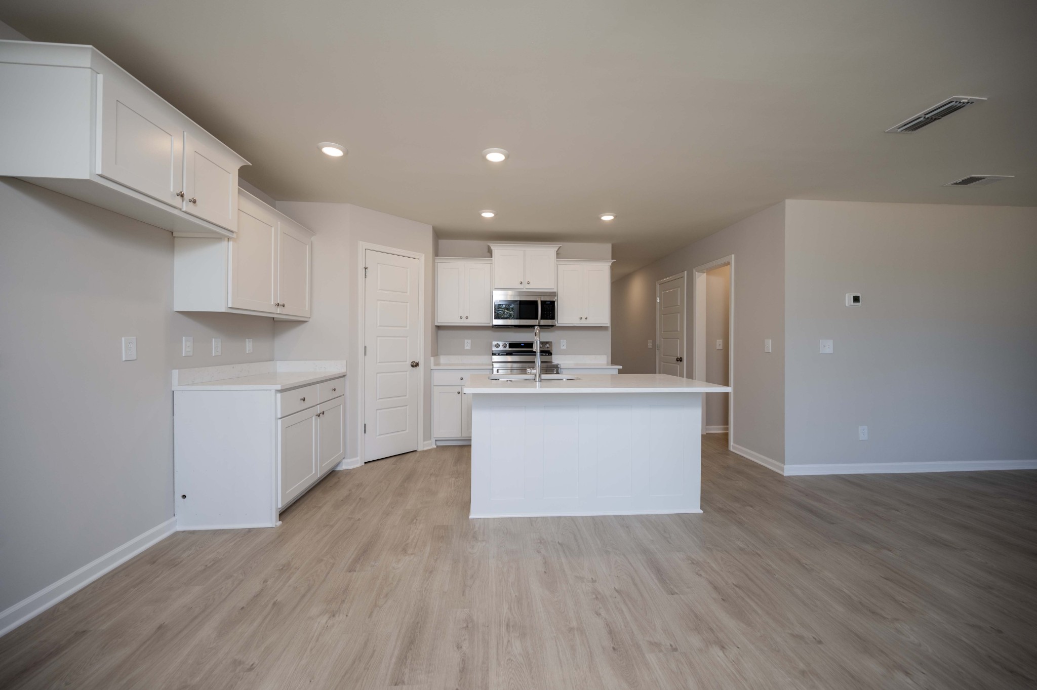 1313 Lakewalk Drive Antioch, TN 37013 - Photo 9 of 28 a kitchen with a refrigerator stove top oven and cabinets