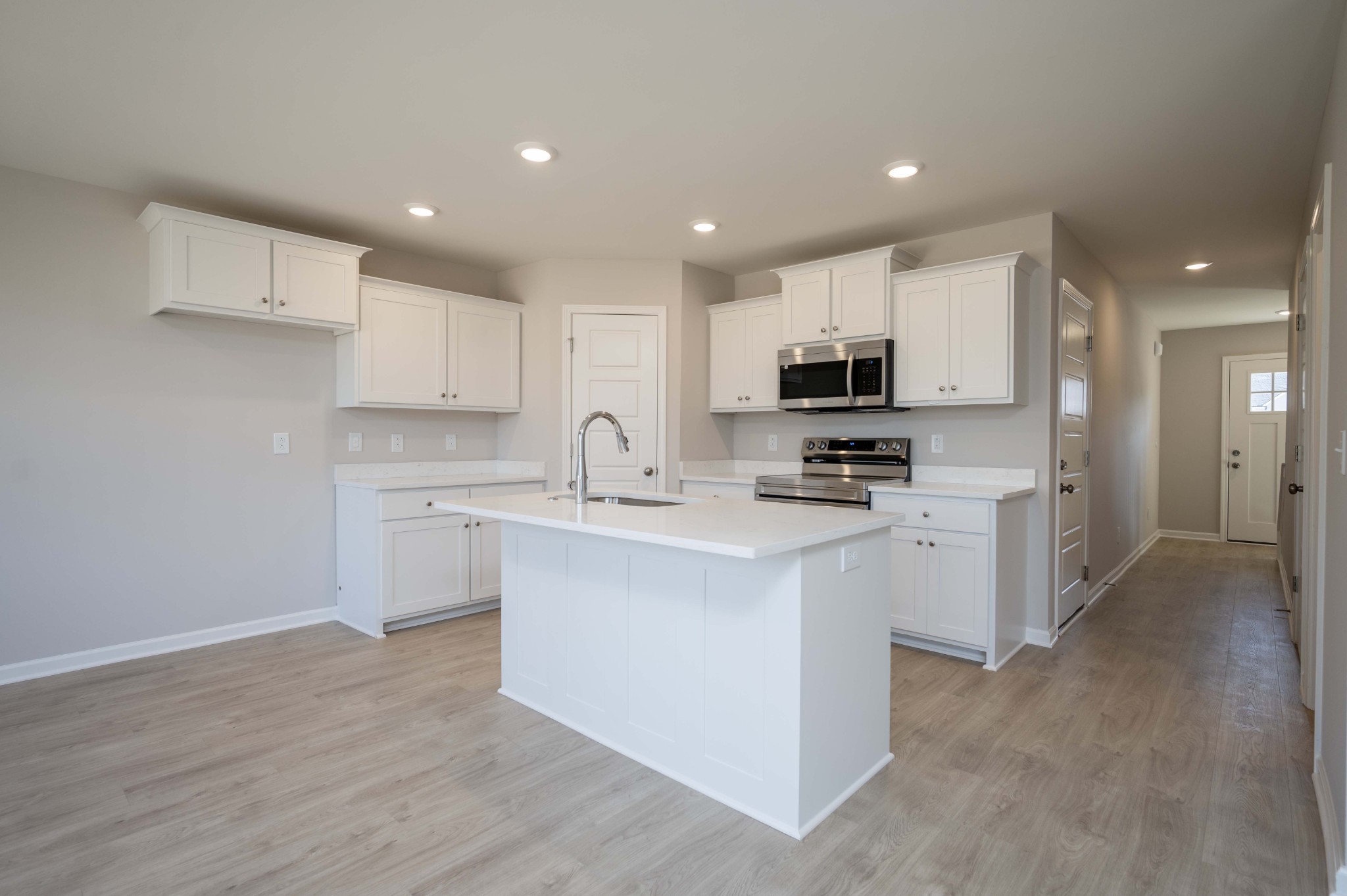 1313 Lakewalk Drive Antioch, TN 37013 - Photo 10 of 28 a kitchen with kitchen island granite countertop a sink a stove a refrigerator and white cabinets