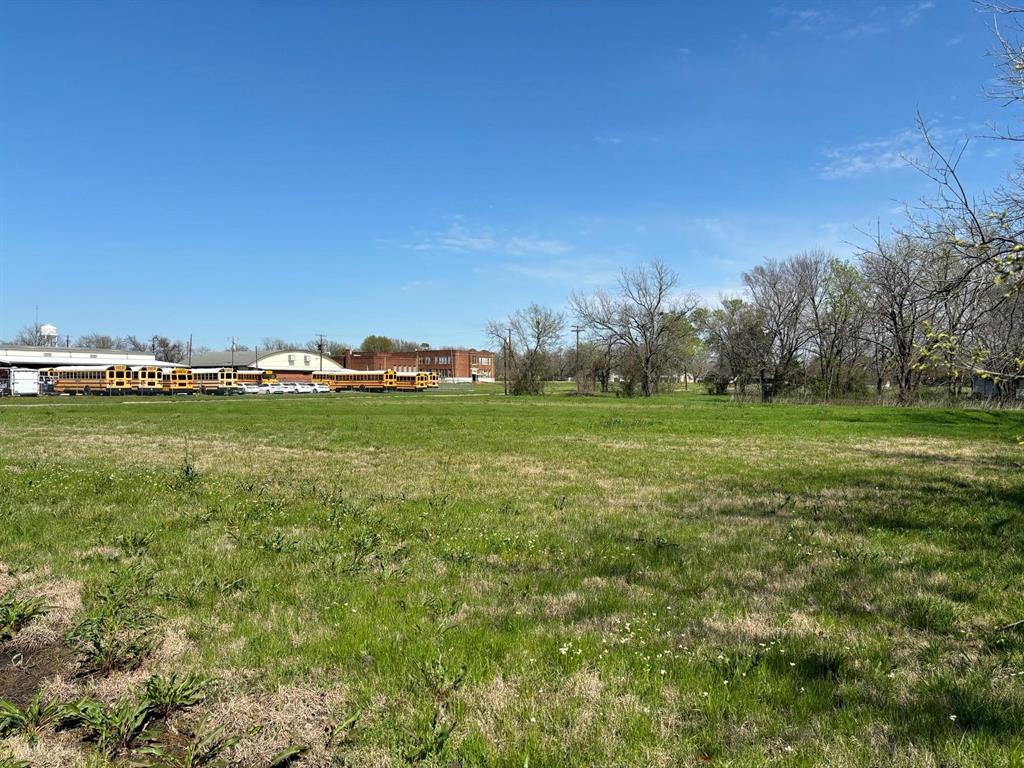 9 Southwest 6th Street Cooper, TX 75432 - Photo 2 of 3 a view of a grassy field with an trees