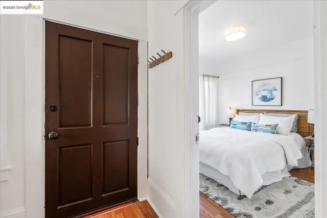 a bedroom with a bed and a painting on the wall