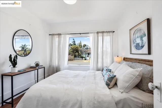 a bedroom with a bed and a painting on the wall