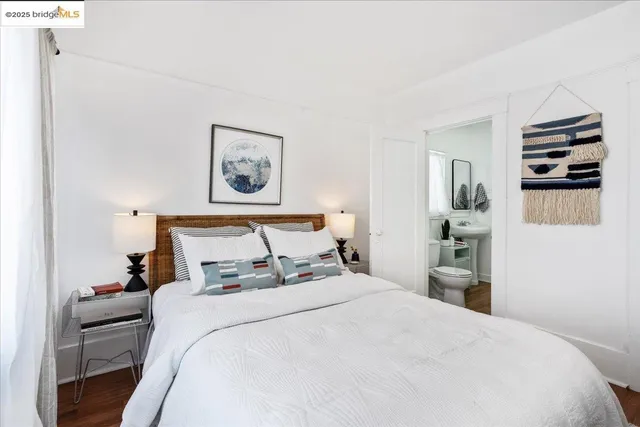 a bedroom with a bed and a view of kitchen