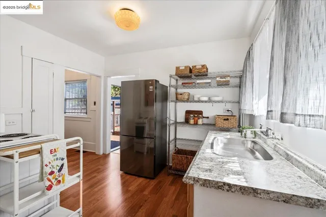 a kitchen with stainless steel appliances granite countertop a sink refrigerator and microwave