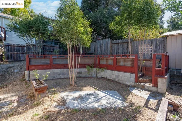 a backyard of a house with barbeque oven