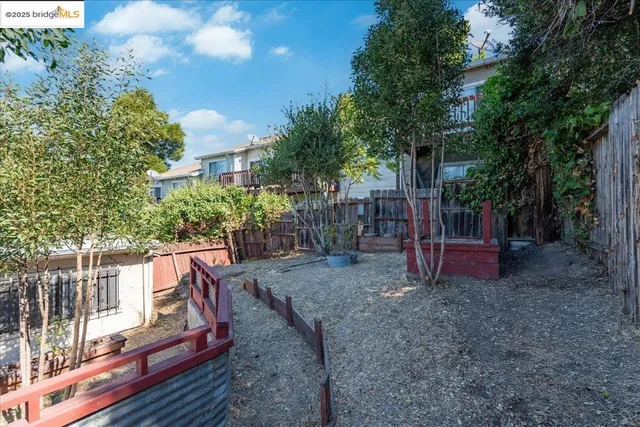 a view of a wooden deck with chairs and a yard
