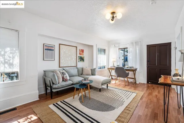 a living room with furniture a rug and a window