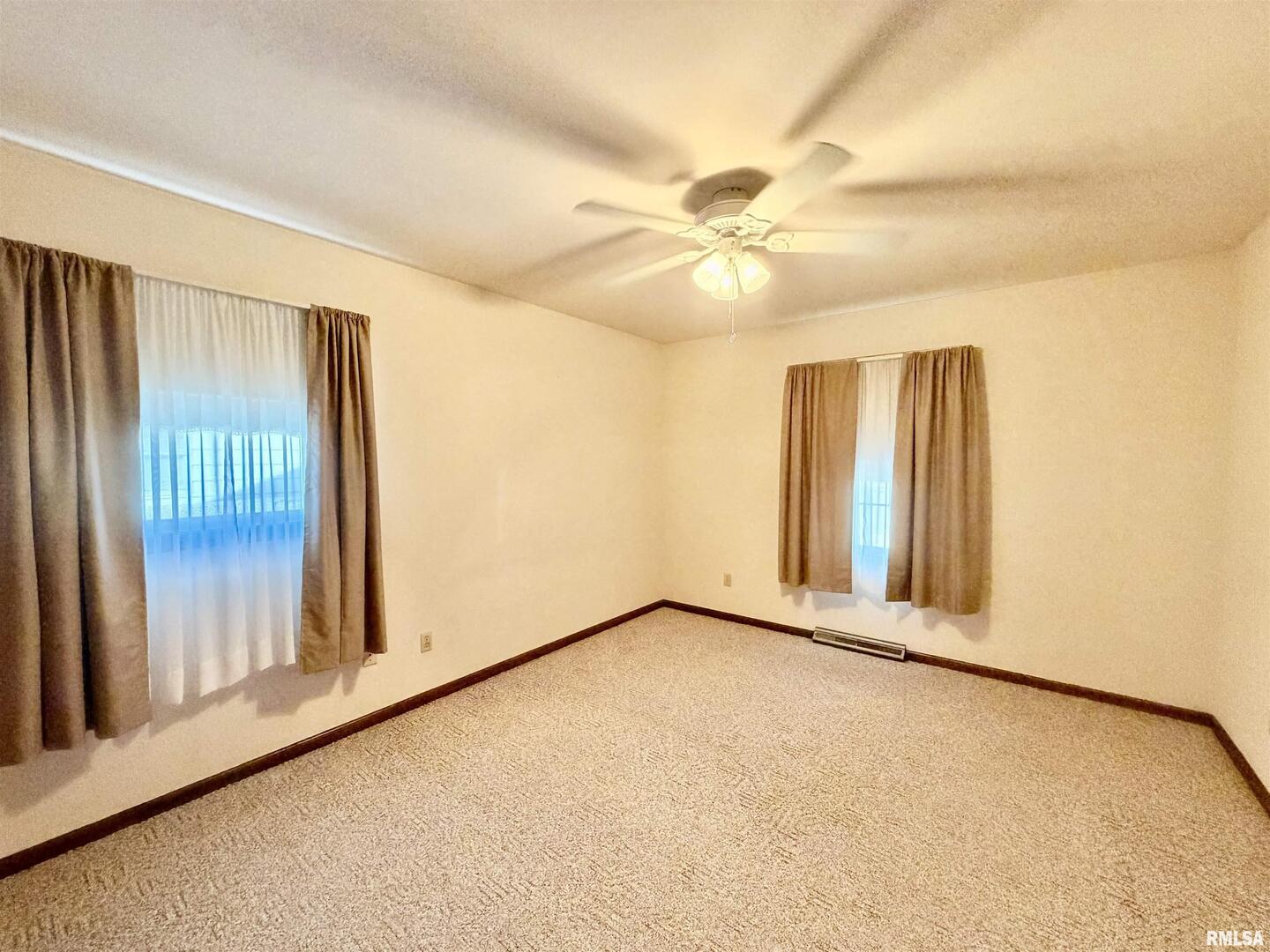 540 Meadowbrook Lane Centralia, IL 62801 - Photo 7 of 14 an empty room with windows and fan