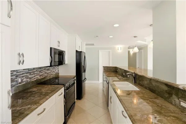 a kitchen with a sink stove and refrigerator