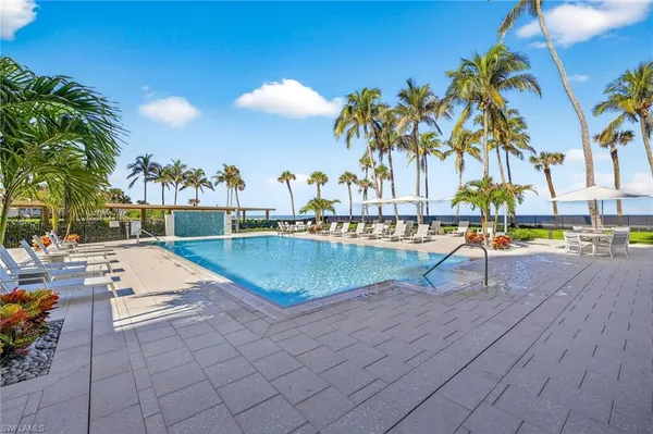 a view of swimming pool with outdoor seating and plants