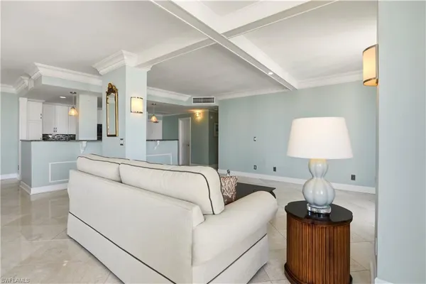a living room with furniture and a lamp