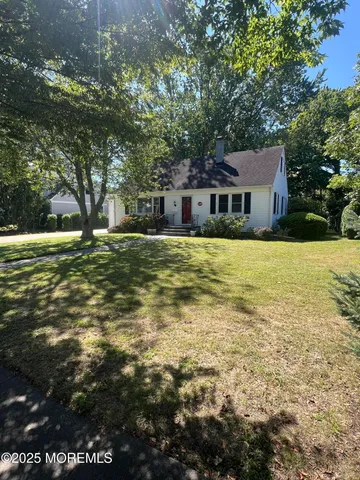 a front view of house with yard and trees