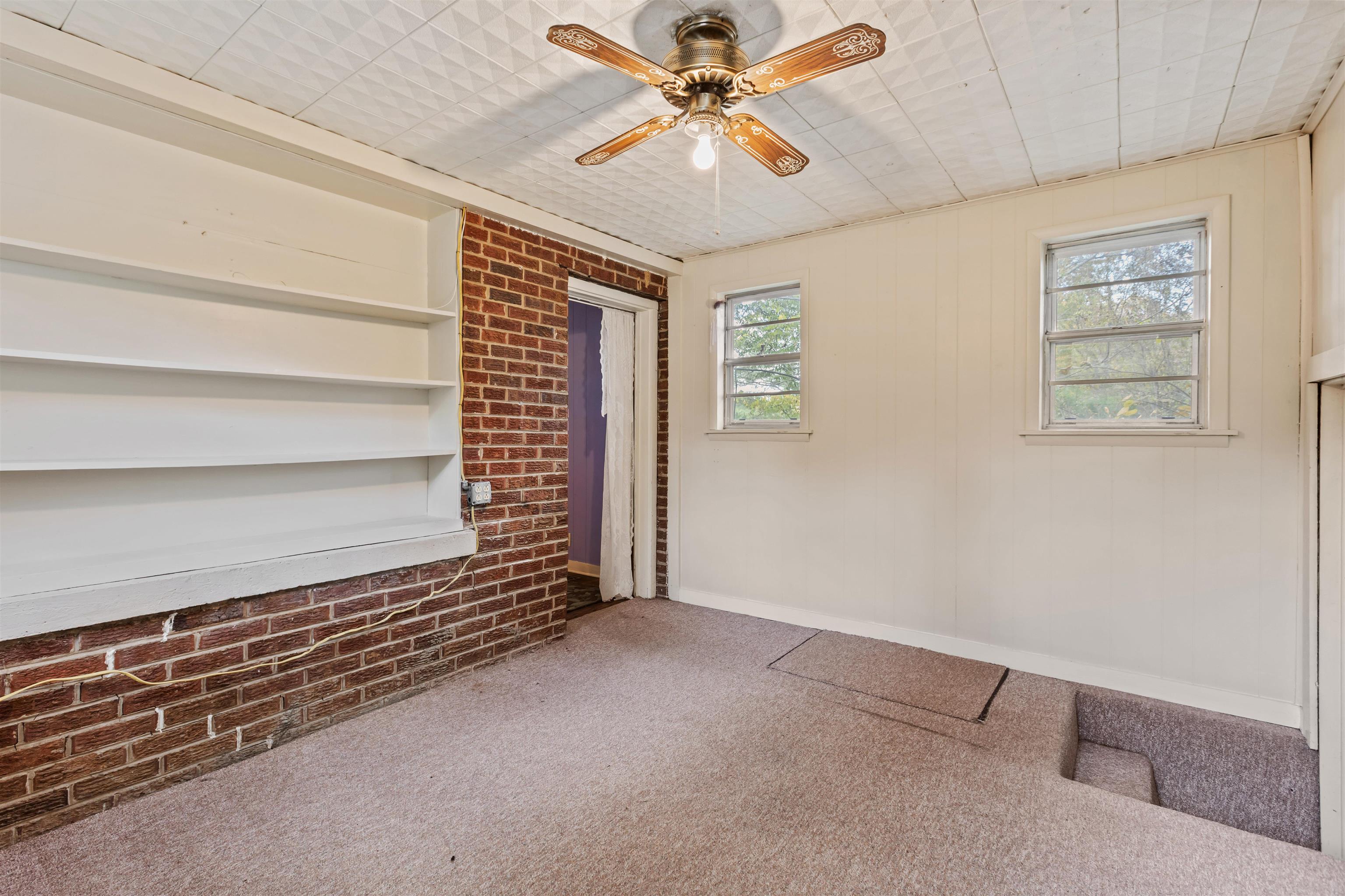 125 Keough Road Collierville, TN 38017 - Photo 15 of 19 a view of a livingroom with a ceiling fan and window