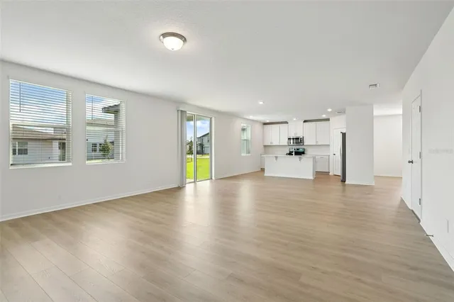 a view of a kitchen with a refrigerator and a sink