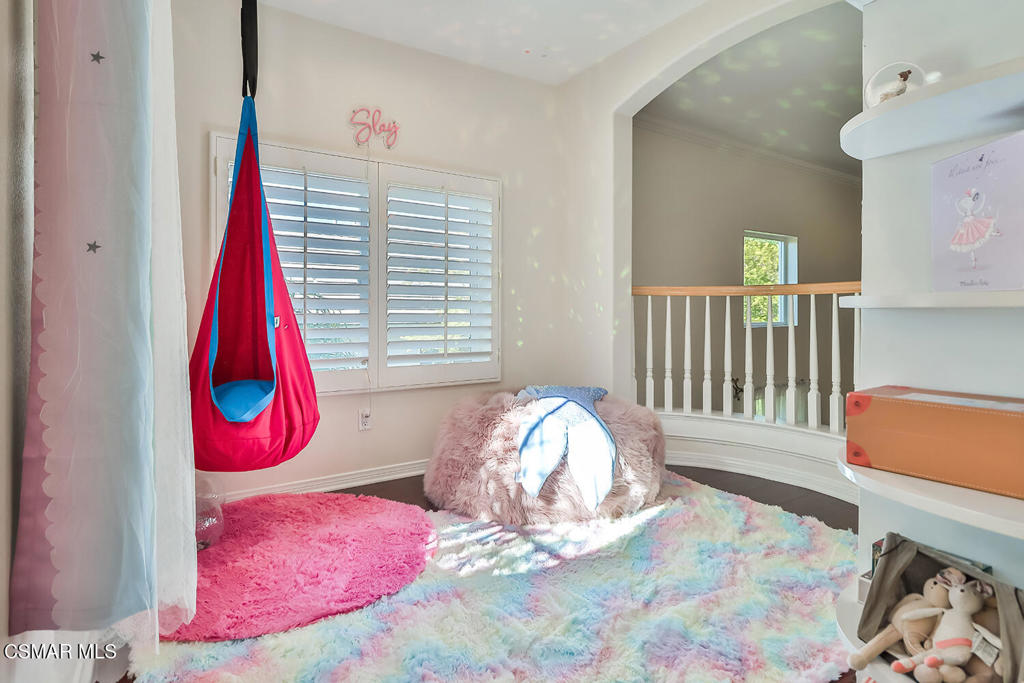 6291 Deerbrook Road Oak Park, CA 91377 - Photo 26 of 29 a view of a bedroom with a bed and wooden floor